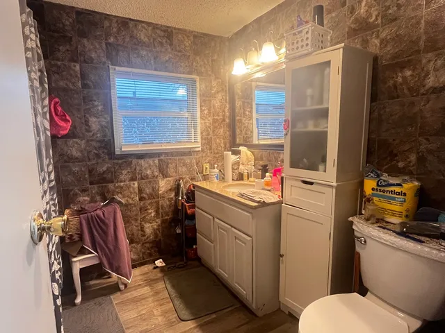 a bathroom with a sink toilet and shower