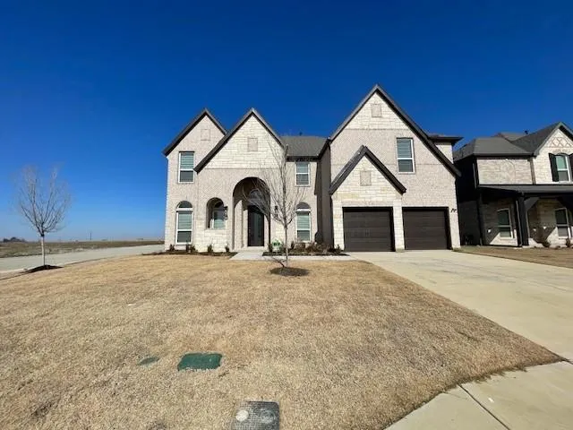 a view of a house with a yard and garage