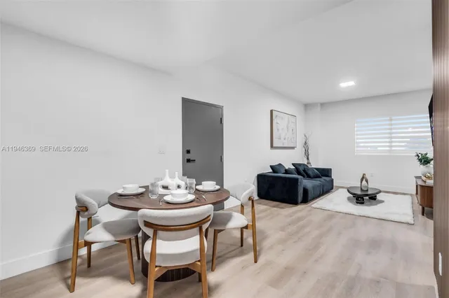 a view of a dining room with furniture and window
