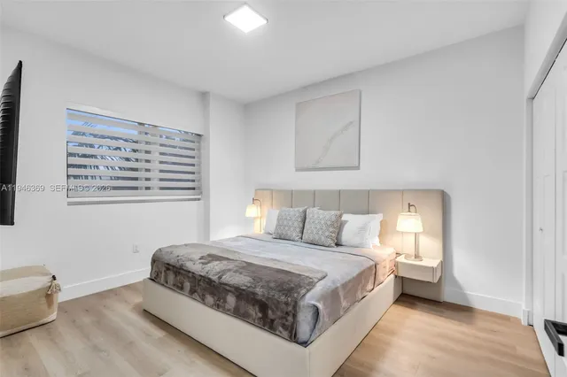 a spacious bedroom with a bed and a window