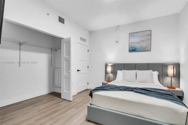 a bedroom with a bed and a night stand