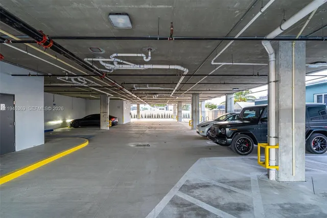 a view of parking garage with cars