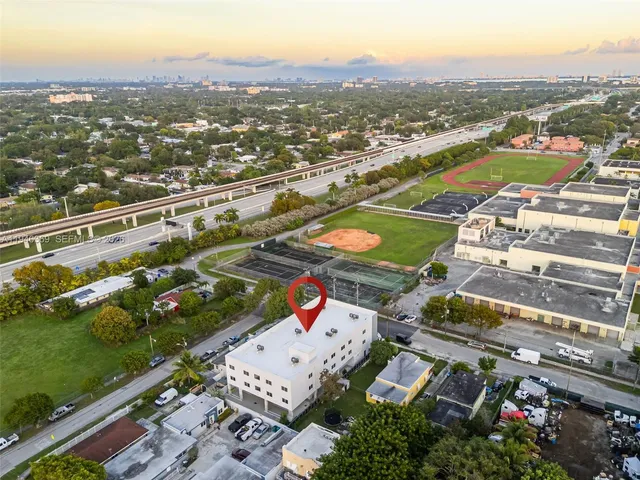 an aerial view of residential houses with outdoor space