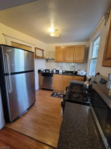 a kitchen with a refrigerator and a stove top oven