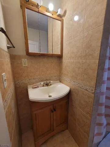 a bathroom with a sink a toilet and mirror