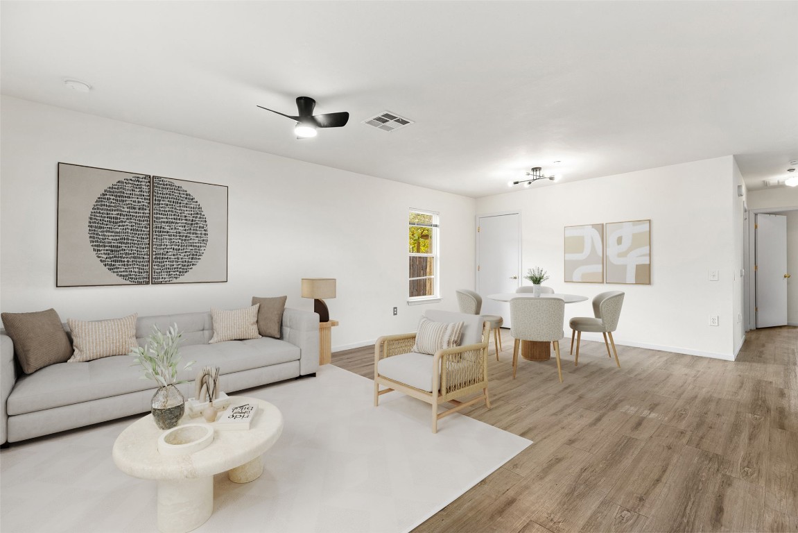 a living room with furniture and a wooden floor