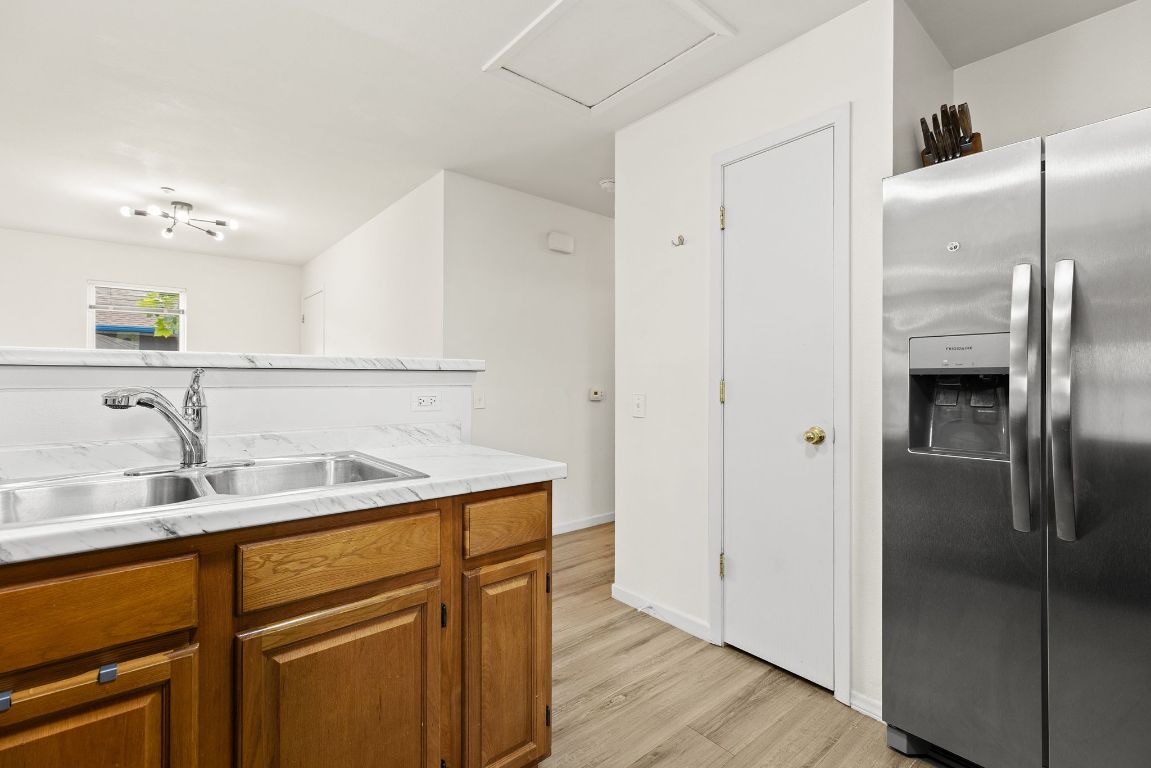 6110 Devonshire Cove Austin, TX 78723 - Photo 14 of 31 a kitchen with a sink and a refrigerator