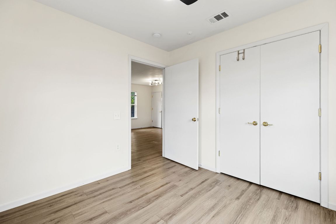 6110 Devonshire Cove Austin, TX 78723 - Photo 21 of 31 a view of an empty room with wooden floor