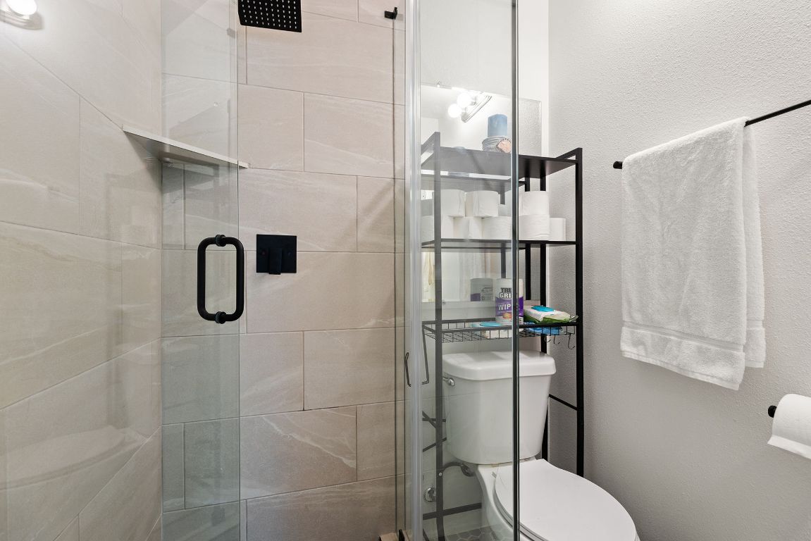6110 Devonshire Cove Austin, TX 78723 - Photo 24 of 31 a bathroom with a toilet and a shower