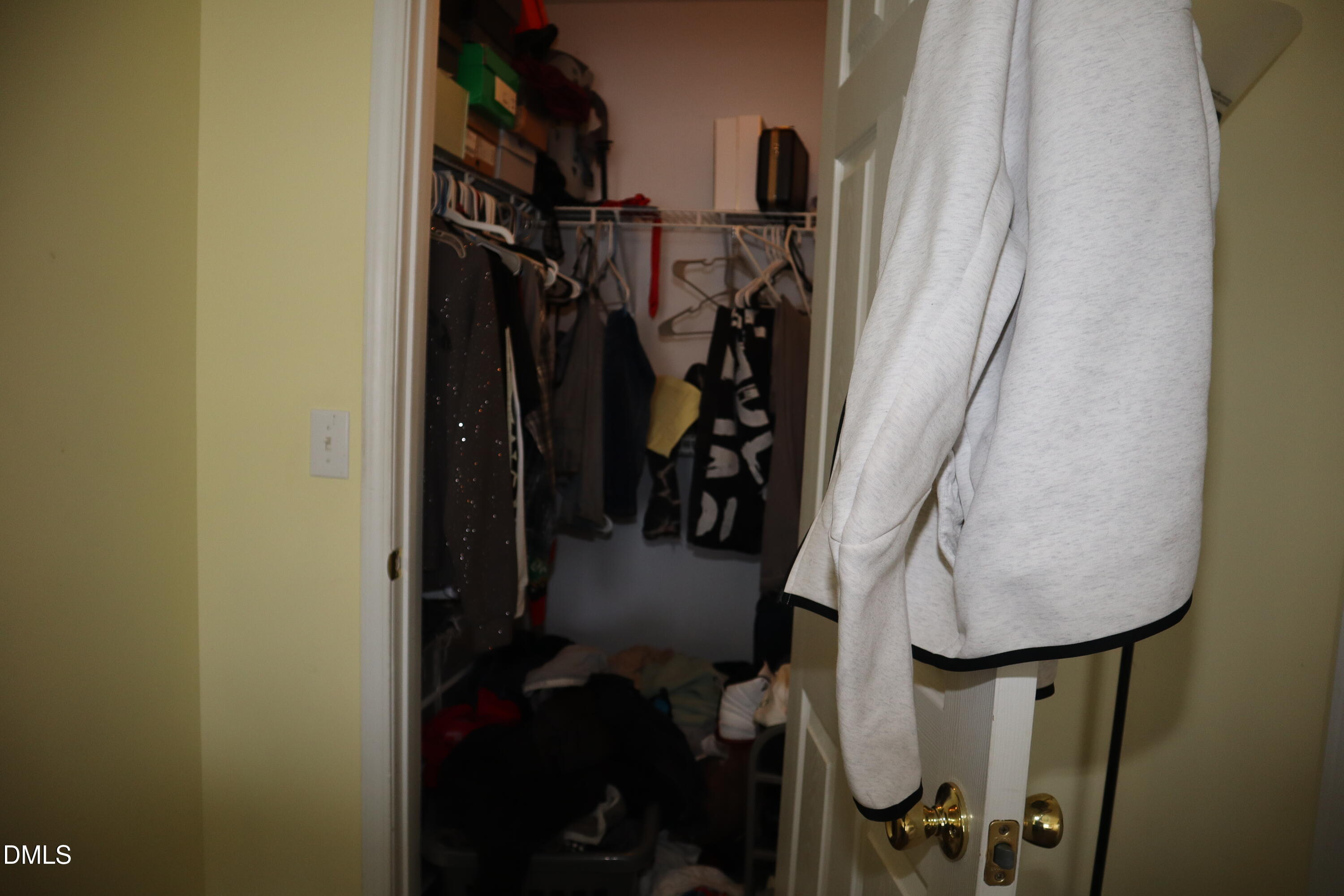 8640 Neuse Landing Lane, Unit 105 Raleigh, NC 27616 - Photo 11 of 16 a view of walk in closet with clothes and shoes