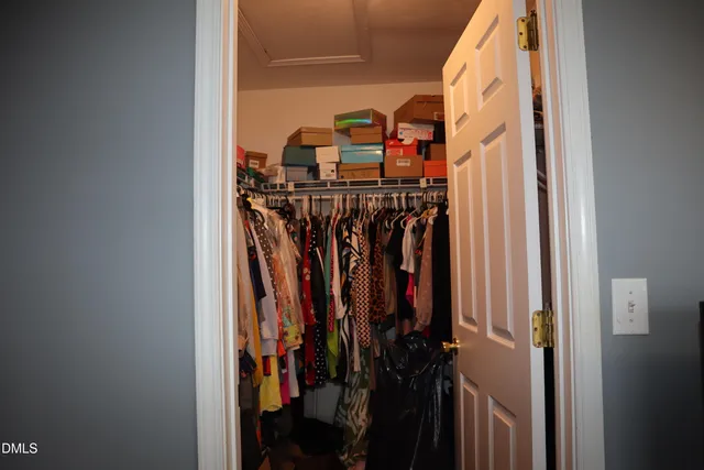 a bedroom with a bed chair and a window