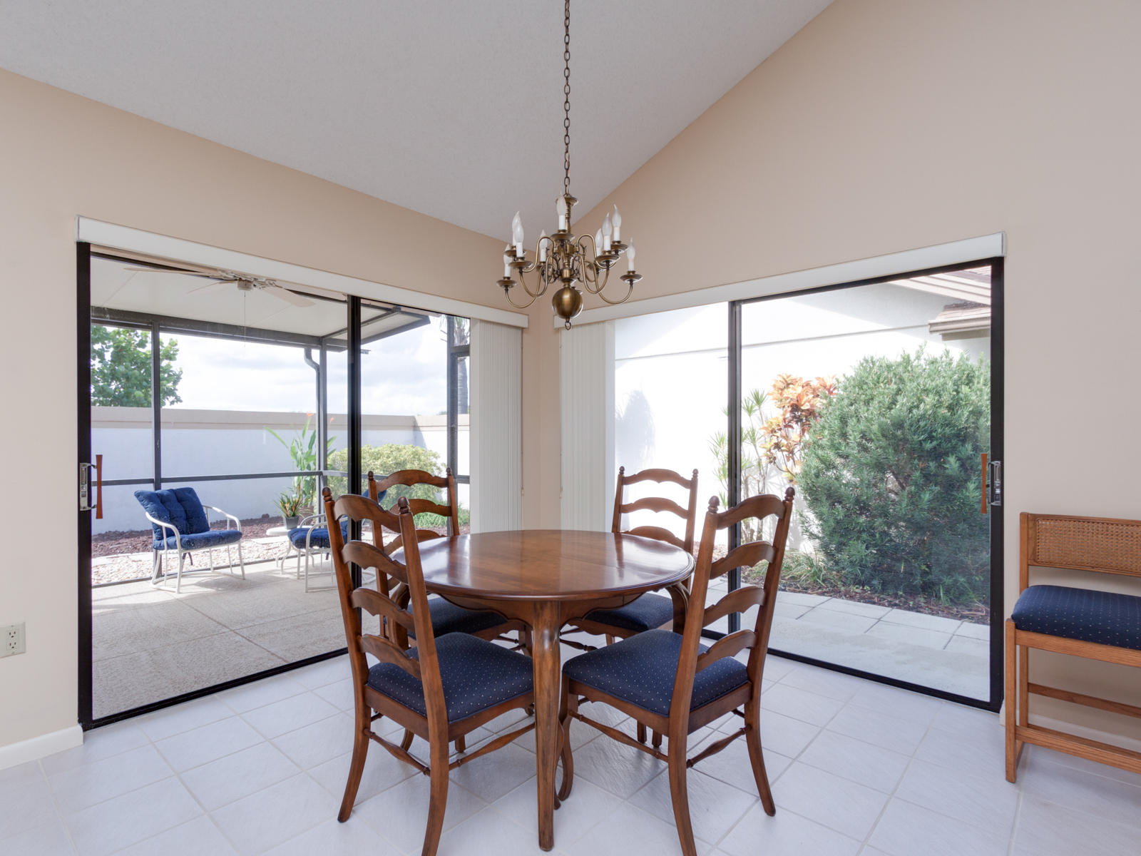 186 Ridge Road Jupiter, FL 33477 - Photo 8 of 44 a dining room with furniture large windows and a chandelier