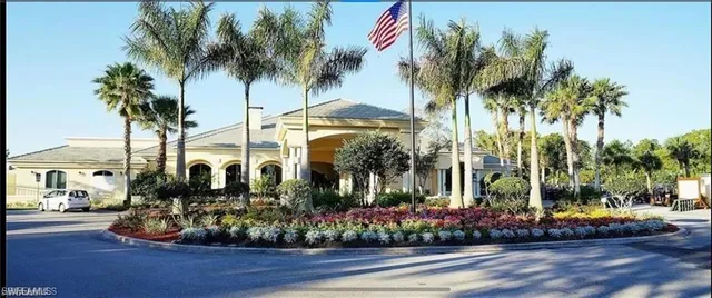 a view of a chairs and table in patio with a lake view