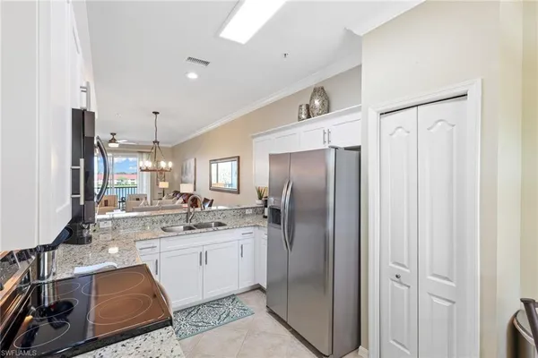 a kitchen with stainless steel appliances a stove a sink and a microwave