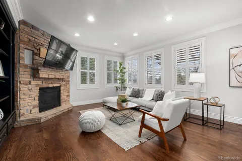 a view of a dining room with furniture a chandelier and wooden floor