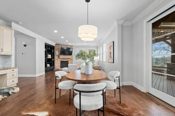 a dining room with furniture and wooden floor