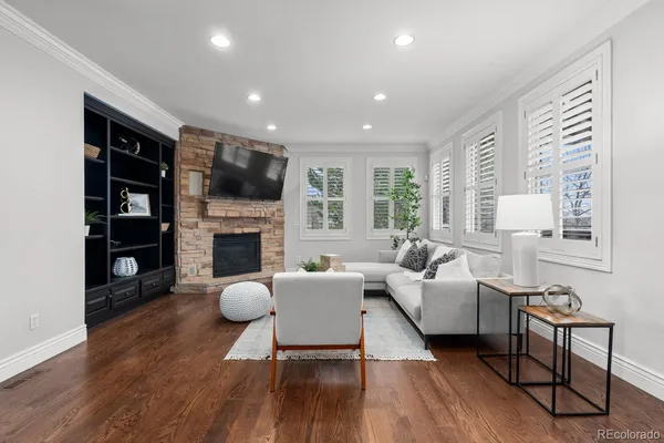 a living room with furniture a fireplace and a flat screen tv