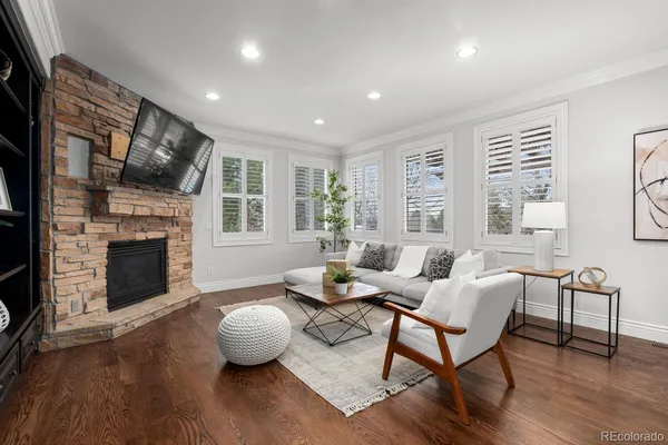 a living room with furniture fireplace and window