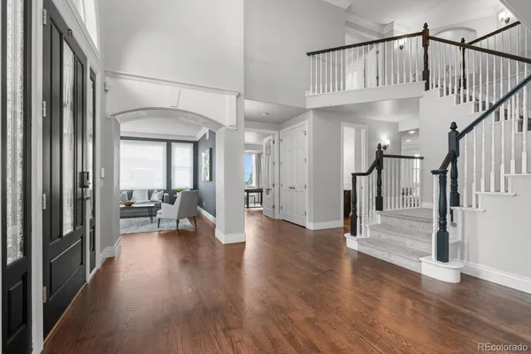 a view of staircase with living room and wooden floor