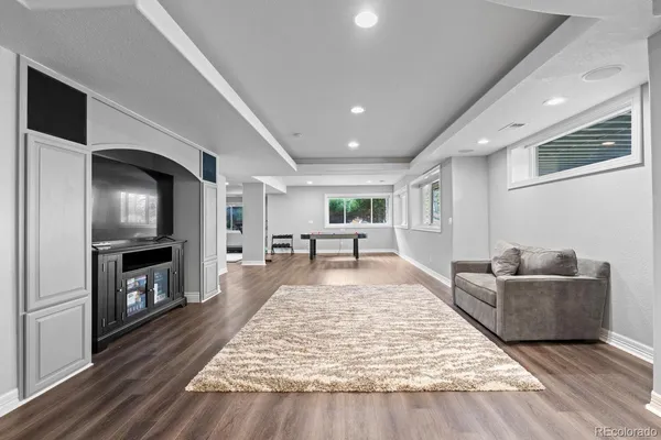a living room with fireplace furniture and a flat screen tv