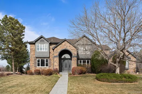 a open kitchen with stainless steel appliances granite countertop a stove top oven a refrigerator a dining table and chairs with wooden floor
