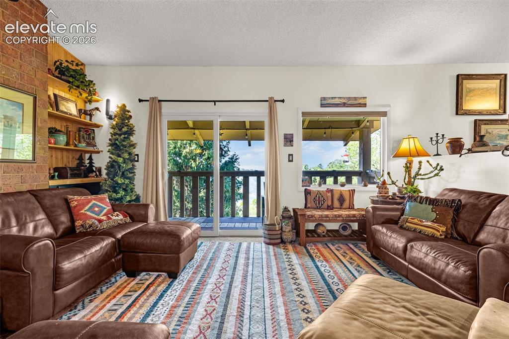 1658 Deer Creek Road Monument, CO 80132 - Photo 7 of 21 Family room walks out to large covered patio with lake views