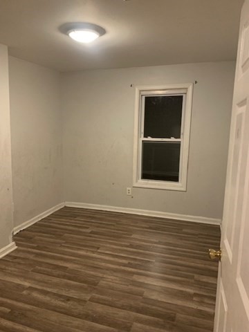 174 Jencks Street, Unit 3 Fall River, MA 02723 - Photo 3 of 5 a view of an empty room with wooden floor and a window