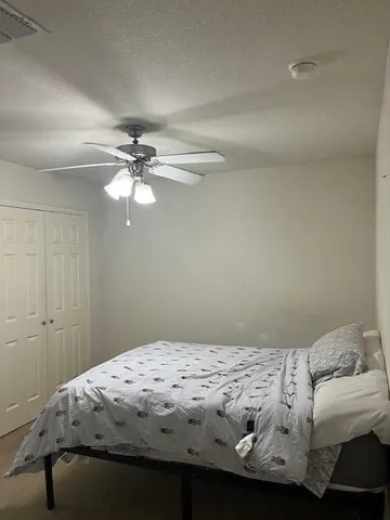 a bedroom with a bed and a chandelier