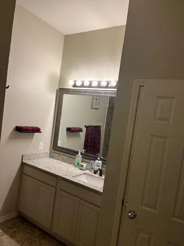 a bathroom with a double vanity sink and mirror