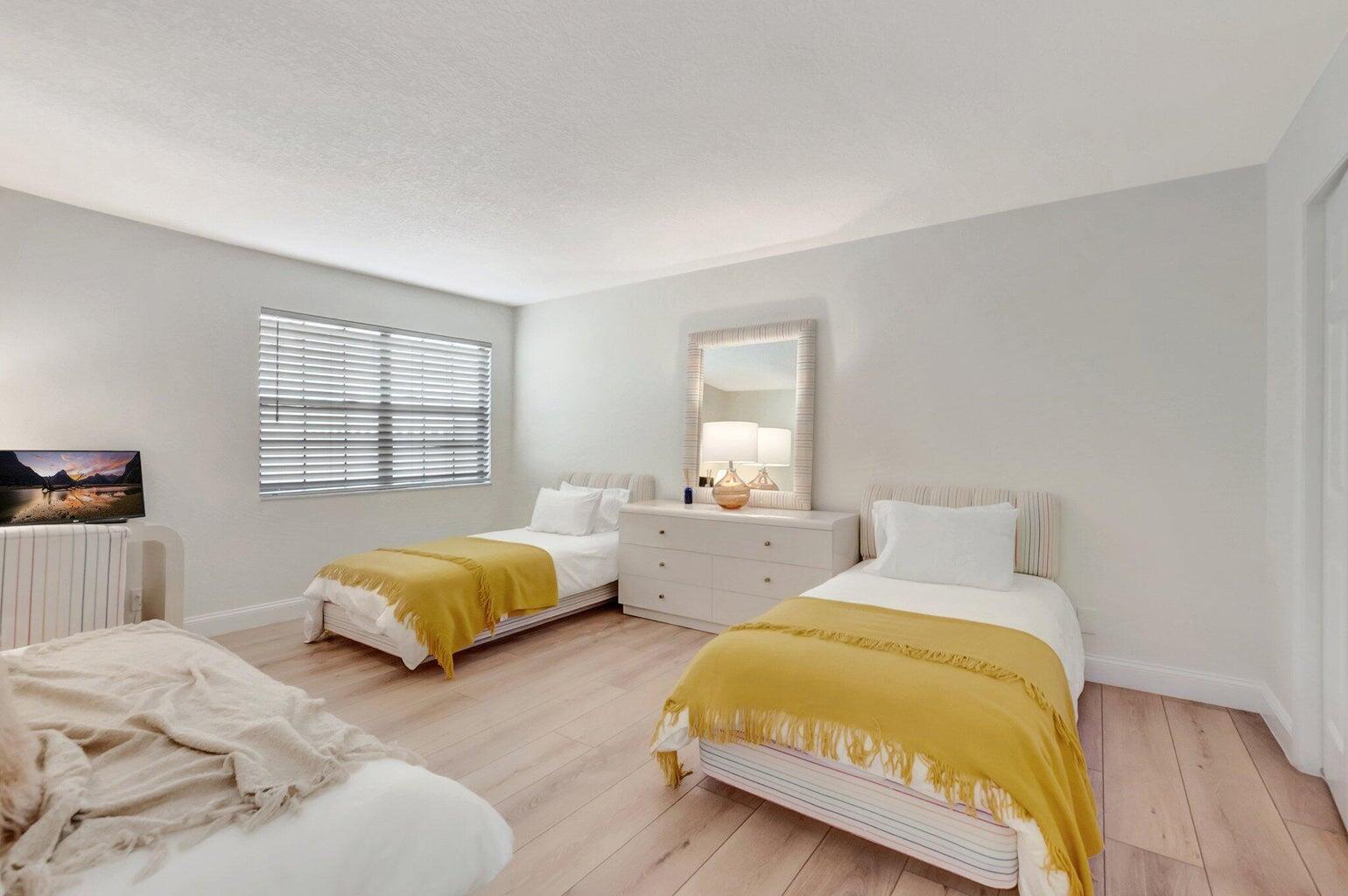 22728 Caravelle Circle Boca Raton, FL 33433 - Photo 14 of 39 a spacious bedroom with two beds and a window