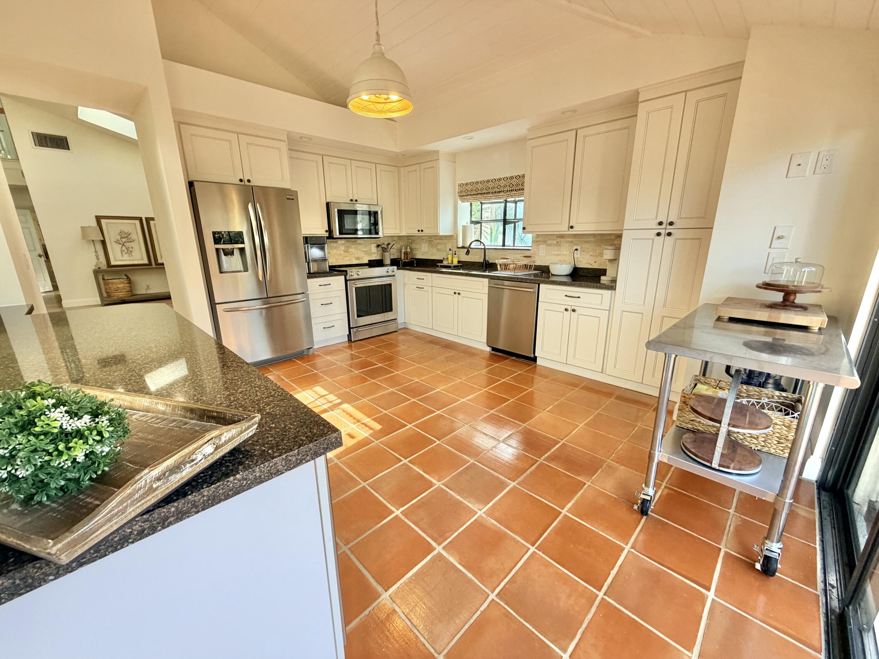 22728 Caravelle Circle Boca Raton, FL 33433 - Photo 31 of 39 a kitchen with stainless steel appliances granite countertop a sink stove and refrigerator