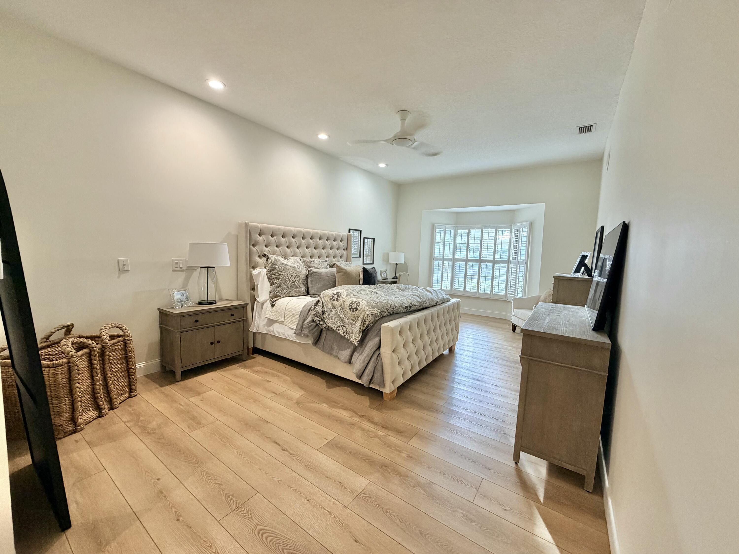 22728 Caravelle Circle Boca Raton, FL 33433 - Photo 35 of 39 a bed room with a bed window and a chair