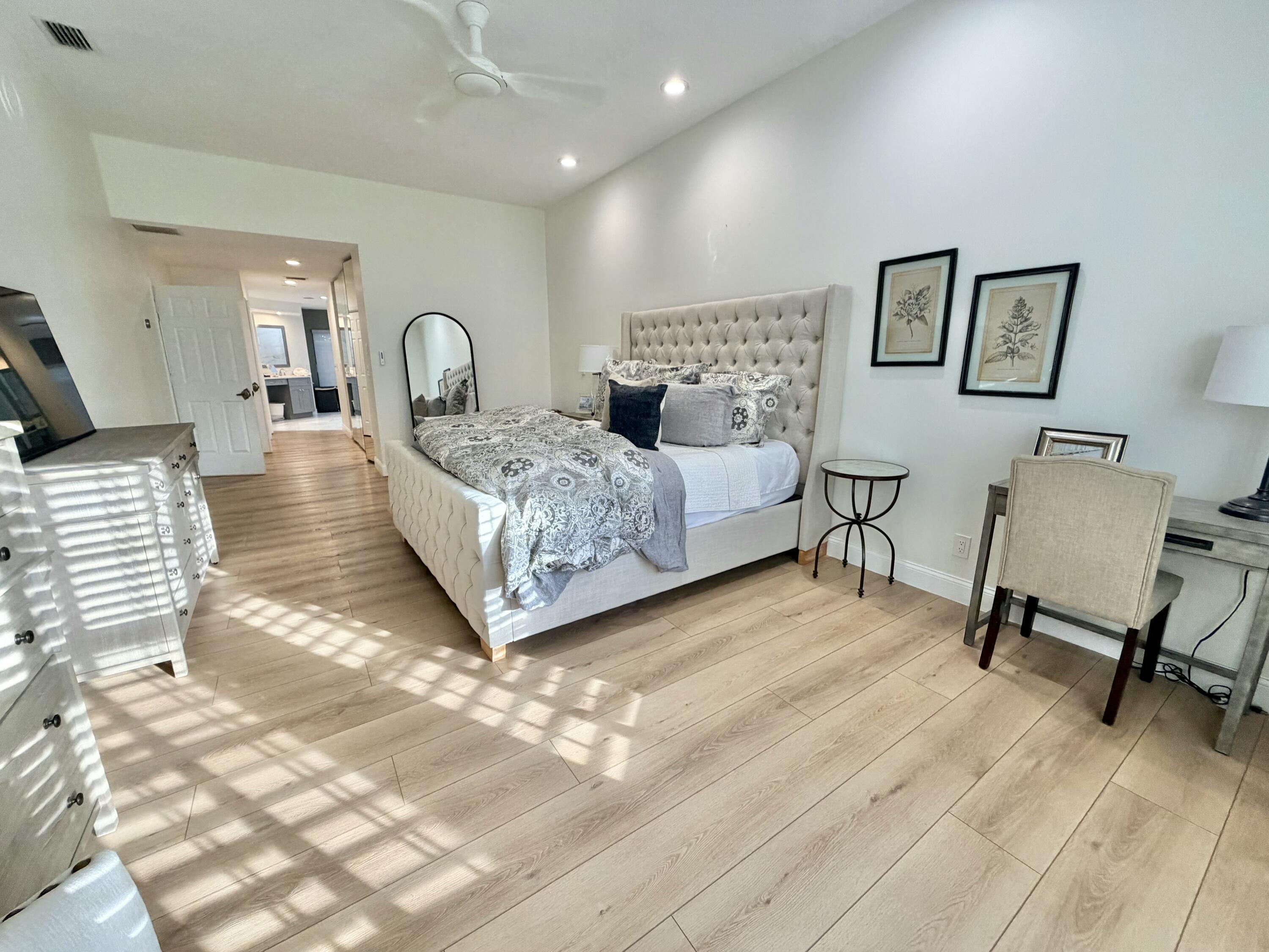 22728 Caravelle Circle Boca Raton, FL 33433 - Photo 37 of 39 a spacious bedroom with a bed a table and chair