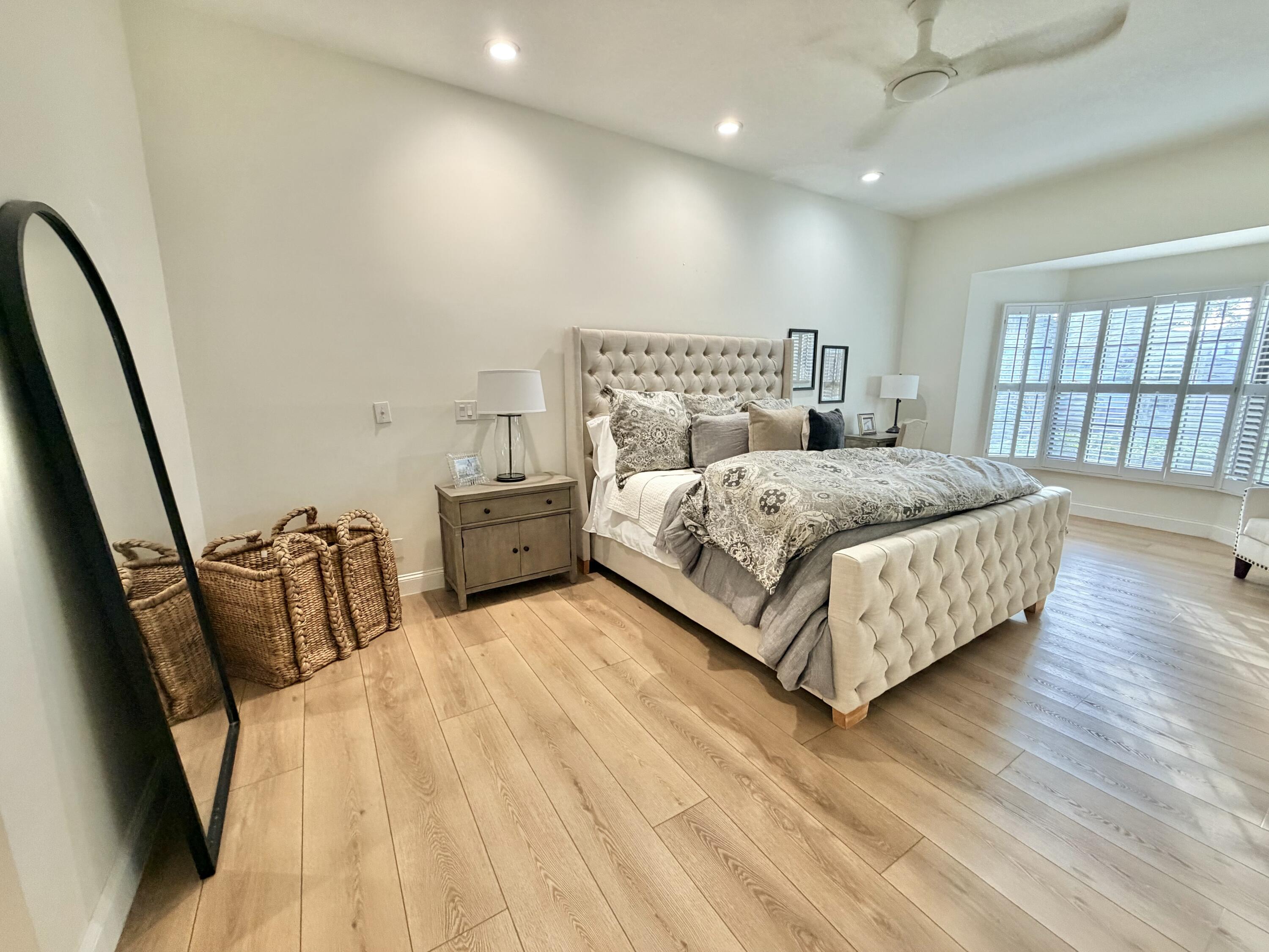 22728 Caravelle Circle Boca Raton, FL 33433 - Photo 38 of 39 a bedroom with a bed and wooden floor