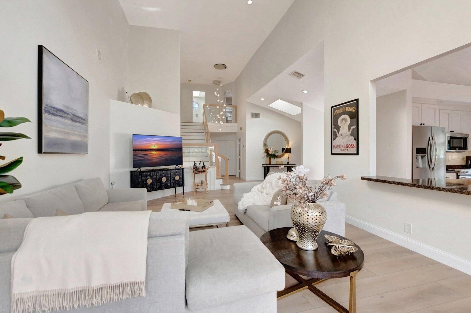 22728 Caravelle Circle Boca Raton, FL 33433 - Photo 5 of 39 a living room with furniture a flat screen tv and a fireplace