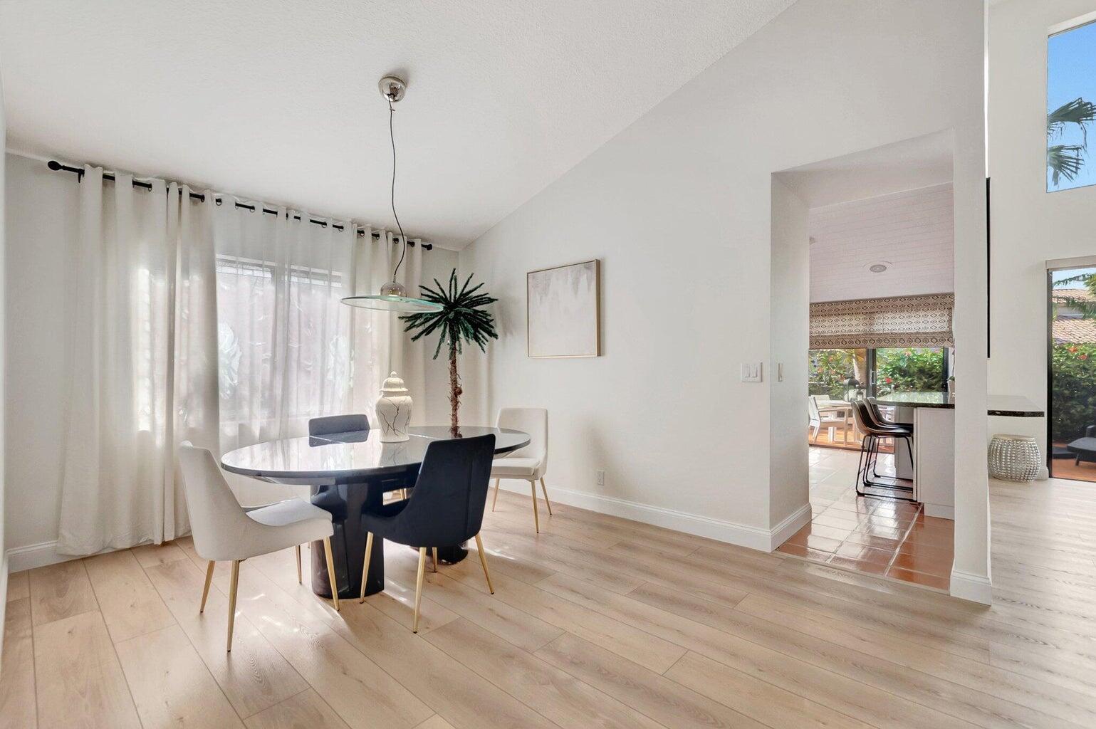 22728 Caravelle Circle Boca Raton, FL 33433 - Photo 6 of 39 a dining room with furniture window entryway and wooden floor