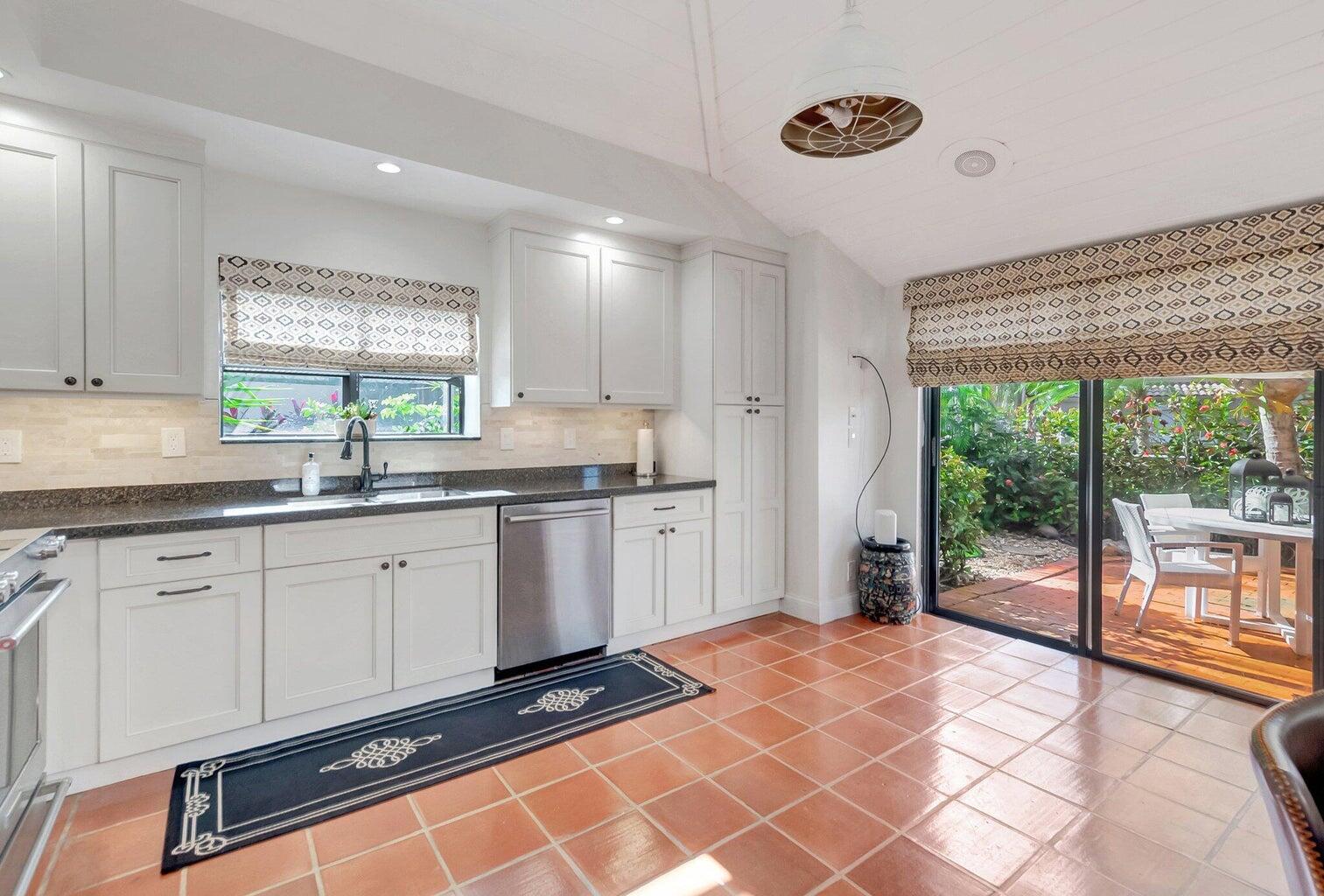 22728 Caravelle Circle Boca Raton, FL 33433 - Photo 7 of 39 a kitchen with a sink a window and cabinets