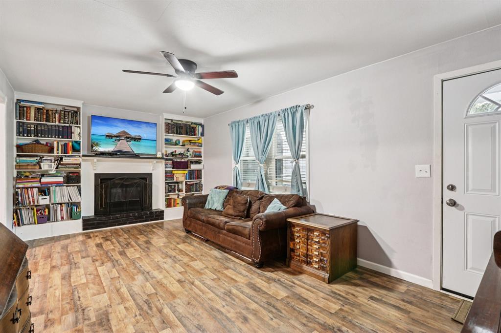 426 West Lake Street Krum, TX 76249 - Photo 3 of 16 a living room with furniture and a fireplace