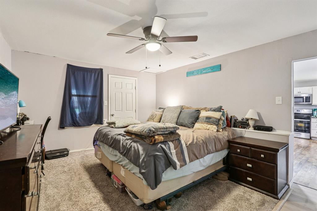 426 West Lake Street Krum, TX 76249 - Photo 8 of 16 a bedroom with bed and window