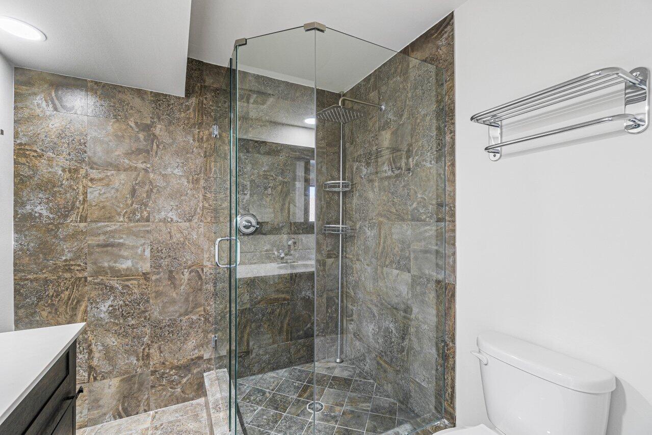 2929 Southwest 22nd Circle, Unit 32B Delray Beach, FL 33445 - Photo 17 of 27 a bathroom with a shower and toilet