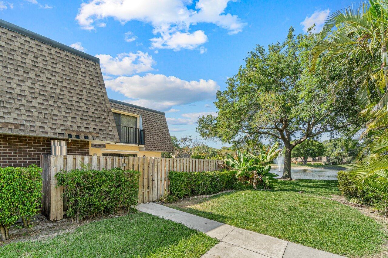 2929 Southwest 22nd Circle, Unit 32B Delray Beach, FL 33445 - Photo 2 of 27 a view of a house with a yard