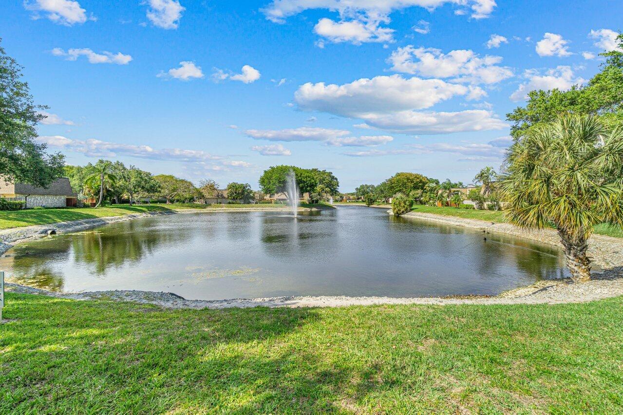 2929 Southwest 22nd Circle, Unit 32B Delray Beach, FL 33445 - Photo 22 of 27 a view of a lake with houses in the back