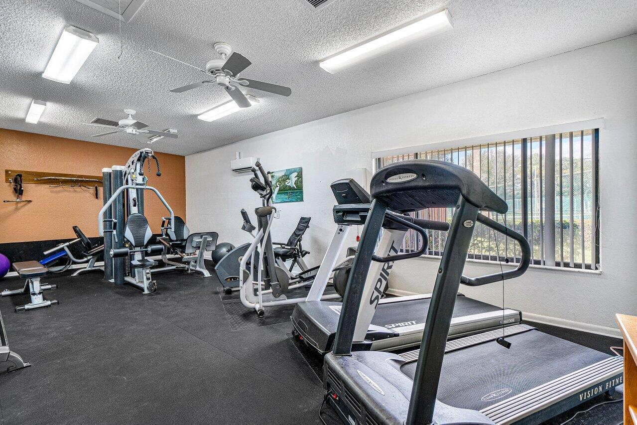 2929 Southwest 22nd Circle, Unit 32B Delray Beach, FL 33445 - Photo 26 of 27 a view of a room with gym equipment
