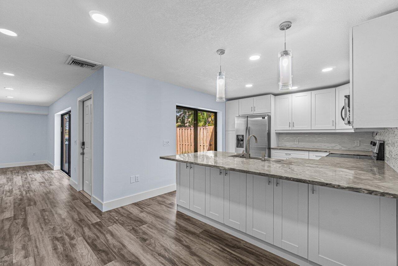2929 Southwest 22nd Circle, Unit 32B Delray Beach, FL 33445 - Photo 5 of 27 a kitchen with a sink window and refrigerator