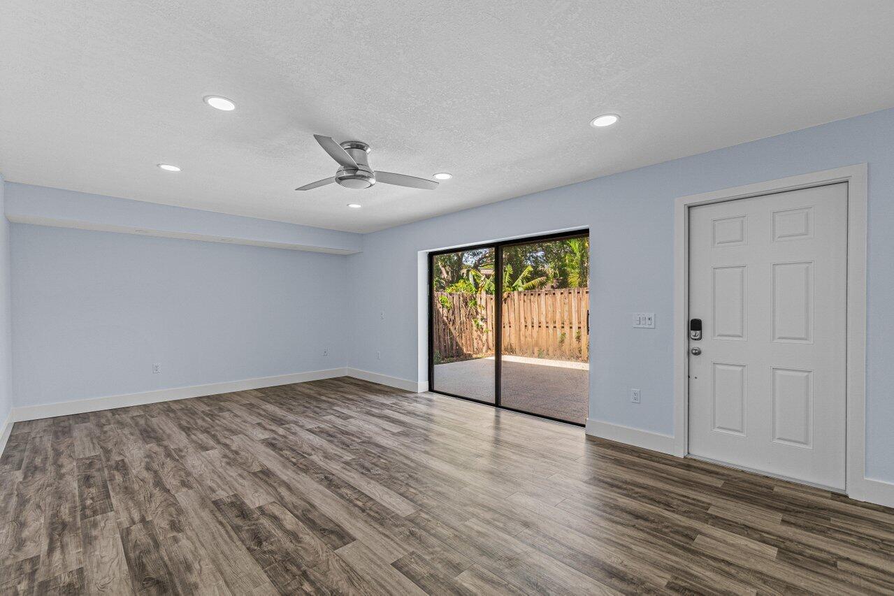 2929 Southwest 22nd Circle, Unit 32B Delray Beach, FL 33445 - Photo 8 of 27 wooden floor in an empty room with a window