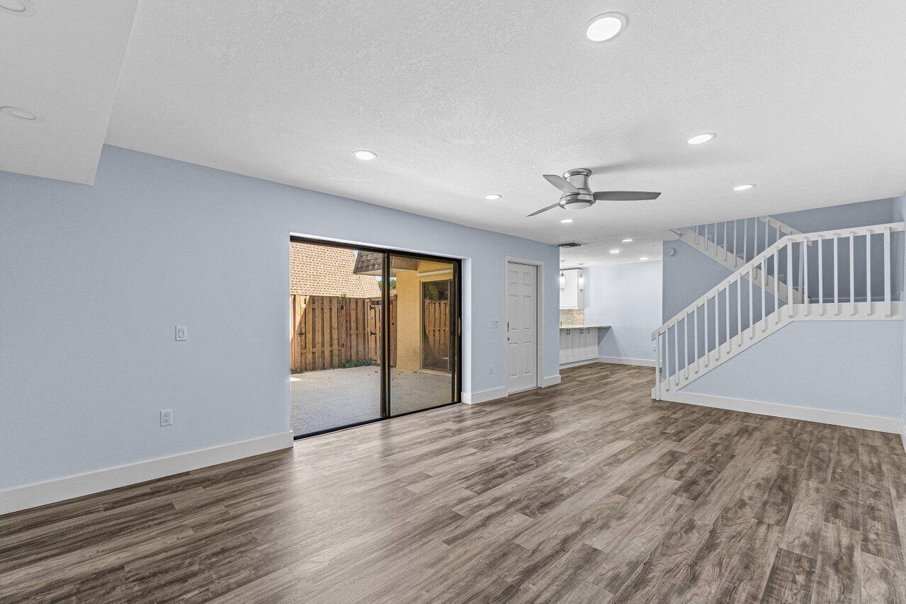 2929 Southwest 22nd Circle, Unit 32B Delray Beach, FL 33445 - Photo 9 of 27 a view of an empty room with wooden floor and a window
