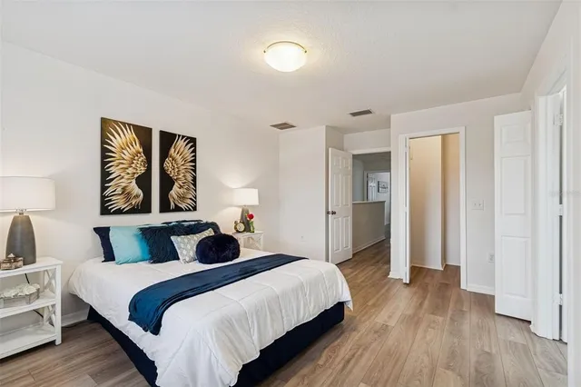 a bedroom with a bed and a painting on the wall