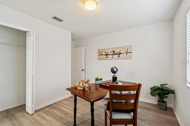 a view of a room with a table and chairs