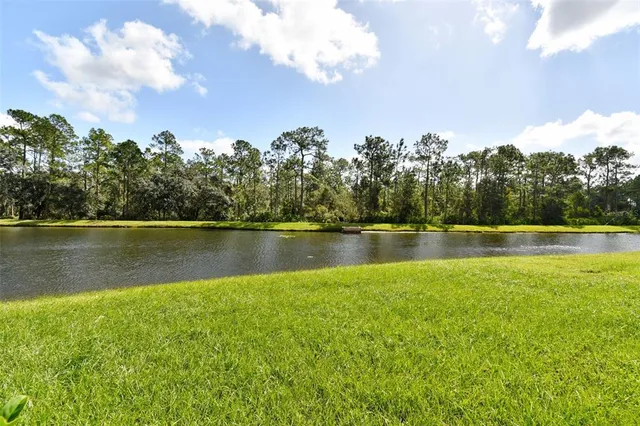 a view of a lake with houses in the background