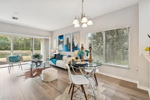 a view of a dining room with furniture wooden floor and chandelier